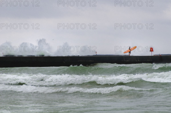 Surfer on Frankfort Pier, Lake Michigan.