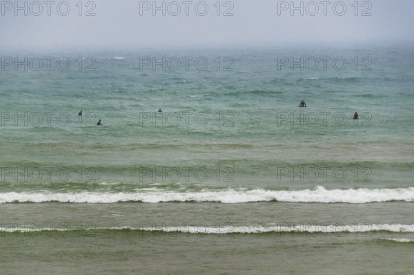 Group of surfers waiting on waves