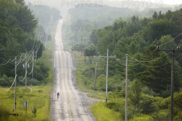 Lone biker on country road