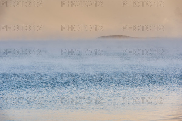 Fog on lake at sunrise