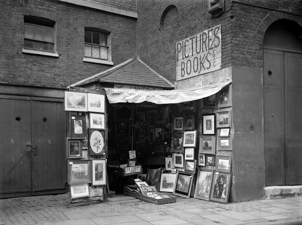 Framed pictures displayed outside a second hand book and picture shop, London, 1933