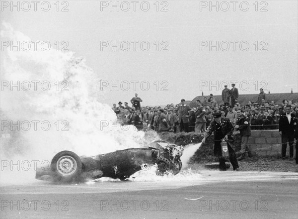 Tony Brooks' car on fire at the British Grand Prix, Silverstone, Northamptonshire,1956. Artist: Unknown