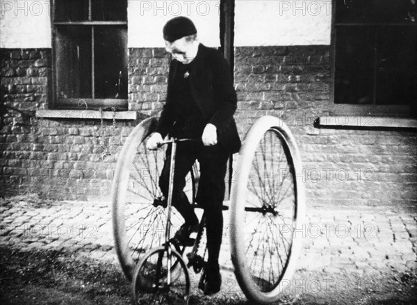 Johnny Dunlop riding his tricycle with rubber tyres, 1888. Artist: Unknown