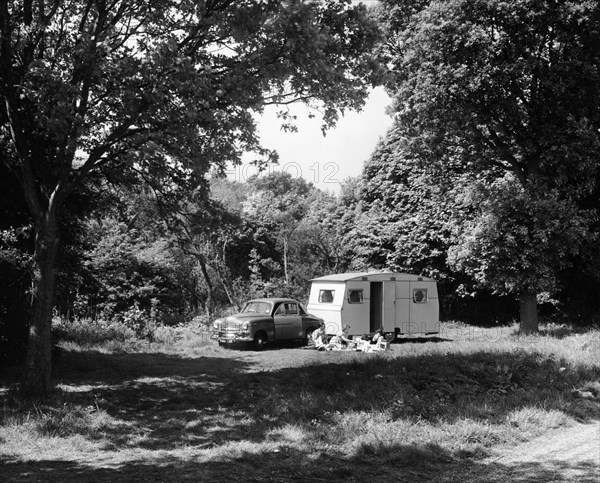 A family relaxing on holiday with their 1951 Vauxhall Wyvern and caravan, (1951?). Artist: Unknown