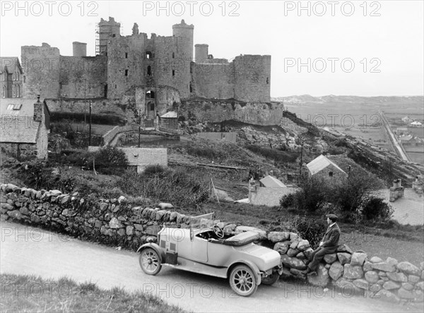 A Singer car in front of Harlech Castle, Wales, early 1920s. Artist: Unknown