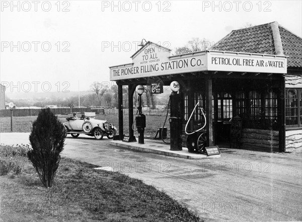 1923 10 hp Calcott arriving at a petrol station, (c1923?). Artist: Unknown