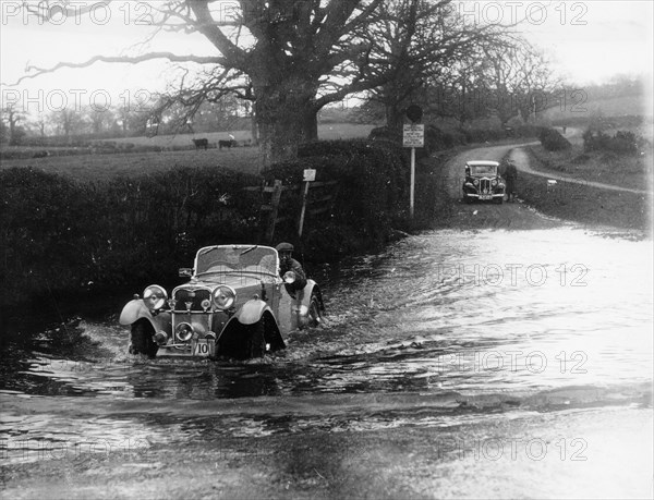 1935 Singer 1.5 Litre Le Mans taking part in a water splash trial, (1935?). Artist: Unknown