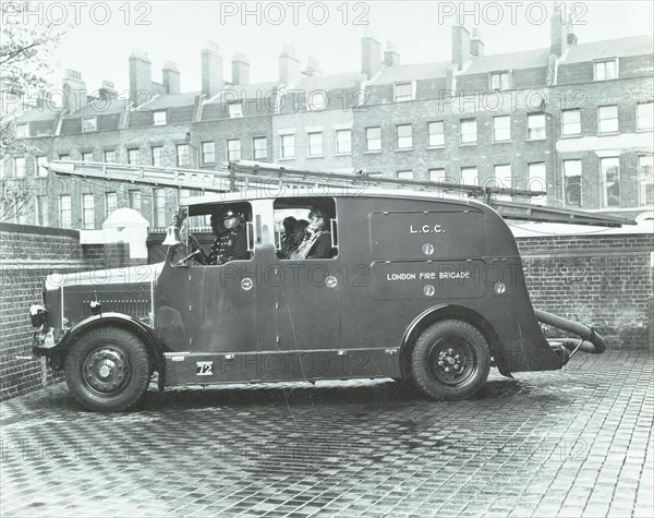 Firemen inside a fire engine, Kingsland Road Fire Station, London, 1935. Artist: Unknown.