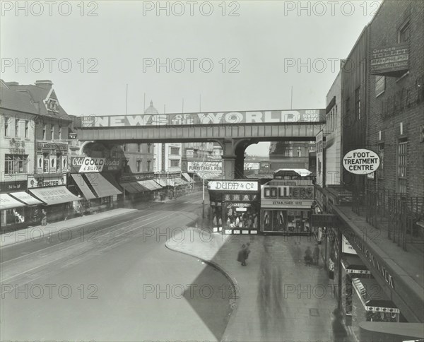 Railway bridge and advertising over the Brixton Road, Lambeth, London, 1938. Artist: Unknown.