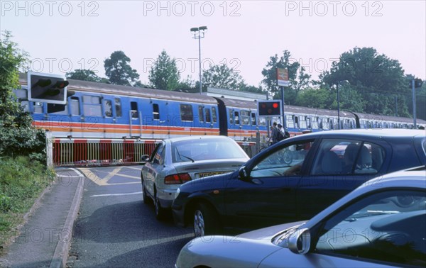 Traffic queue at level crossing in Brockenhurst, Hampshire. Artist: Unknown.