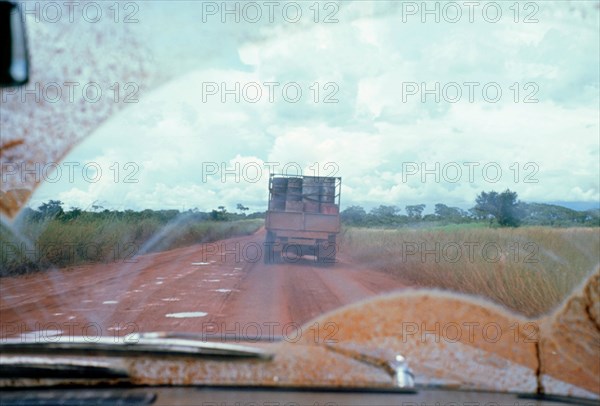 View through muddy windsreen on African dirt road. Artist: Unknown.