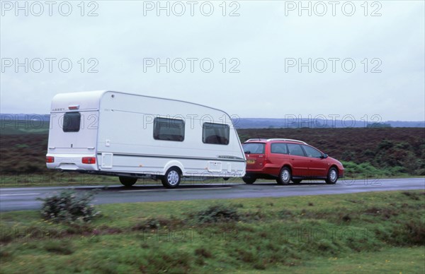 2002 Citroen C5 towing a caravan. Artist: Unknown.