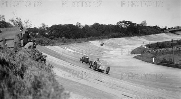 Earl Howe's Delage GP leading ER Hall's Bentley at the BARC Meeting, Brooklands, 25 May 1931. Artist: Bill Brunell.