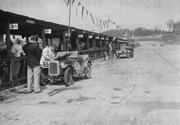 Austin Ulster and MG C type in the pits at the JCC Double Twelve race, Brooklands, 8/9 May 1931. Artist: Bill Brunell.