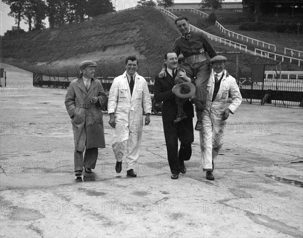 Leon Cushman being carried aloft after making a successful speed record attempt, Brooklands, 1931. Artist: Bill Brunell.