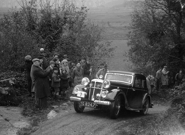 1934 Standard Avon Ten coupe taking part in a Standard Car Owners Club trial. Artist: Bill Brunell.