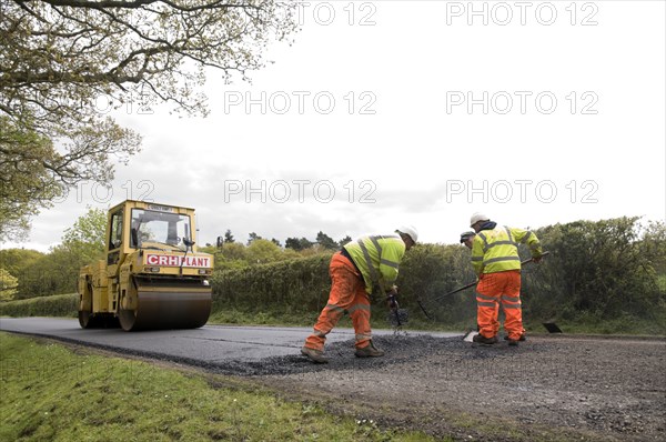 Road resurfacing work repairing potholes Artist: Unknown.