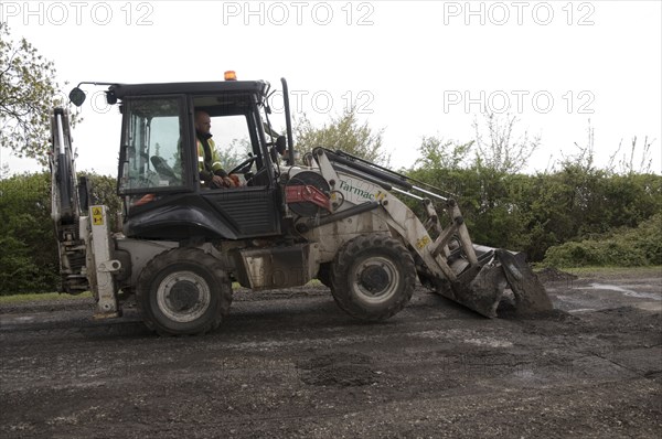 Road resurfacing work repairing potholes Artist: Unknown.