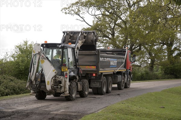 Road resurfacing work repairing potholes Artist: Unknown.