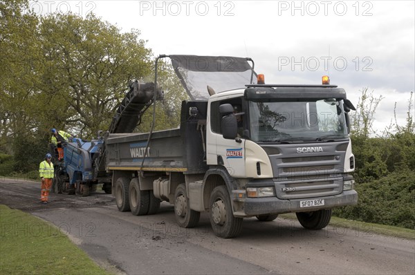 Road resurfacing work repairing potholes Artist: Unknown.