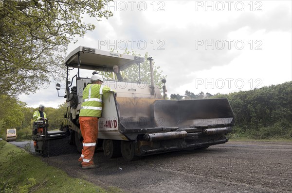 Road resurfacing work repairing potholes Artist: Unknown.