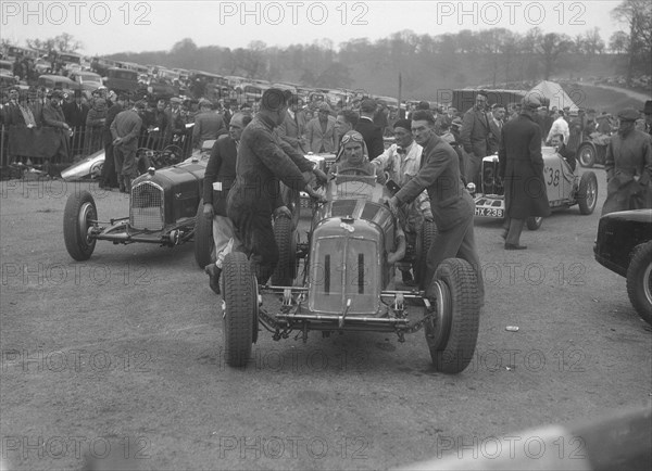 Dick Seaman's ERA, Dick Shuttleworth's Alfa Romeo and a MG Magnette at Donington Park, 1935. Artist: Bill Brunell.