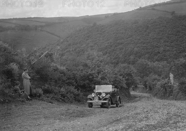 Austin 10 competing in the Mid Surrey AC Barnstaple Trial, Beggars Roost, Devon, 1934. Artist: Bill Brunell.