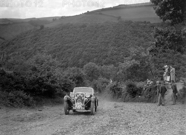 Singer sports competing in the Mid Surrey AC Barnstaple Trial, Beggars Roost, Devon, 1934. Artist: Bill Brunell.