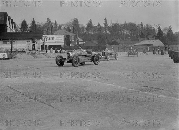 Two Bugatti Type 37s and an MG racing at Brooklands, Surrey, 1930s. Artist: Bill Brunell.