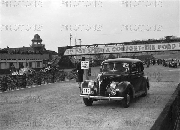 Ford V8 saloon competing in the JCC Rally, Brooklands, Surrey, 1939. Artist: Bill Brunell.