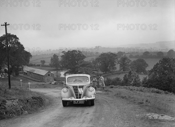 Ford V8 saloon competing in the South Wales Auto Club Welsh Rally, 1937 Artist: Bill Brunell.