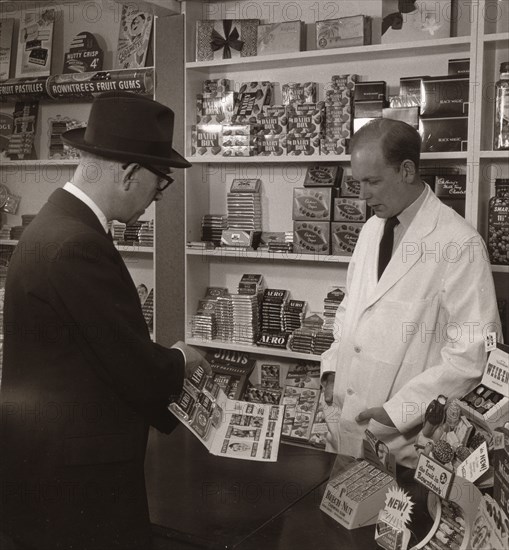 A salesman demonstrating his goods, 1956. Artist: Unknown