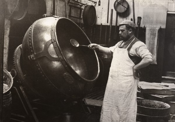 A man in an apron panning chocolate, Rowntree Cocoa Works, York, Yorkshire, 1900. Artist: Unknown