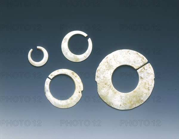 Four altered jade asymmetrical slit-discs, Neolithic, Liangzhu culture, China, c3400-2200 BC. Artist: Unknown