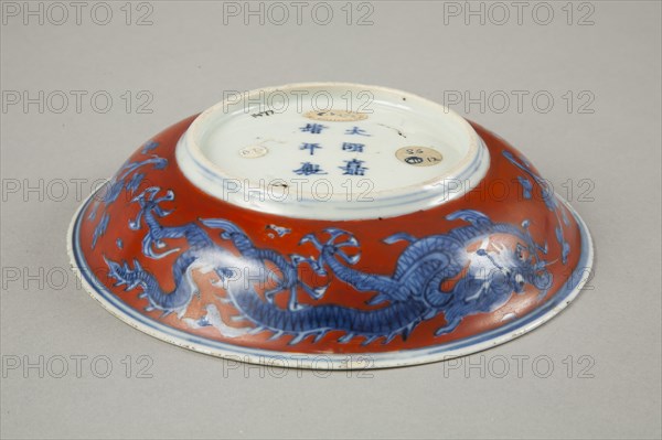 Red clobbered blue and white saucer with stork, phoenix and dragons, Jiajing (1522-1566). Artist: Unknown.