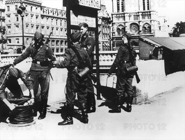 Soldiers with a telephone cable on the Pont St Michel, Paris, June 1940. Artist: Unknown