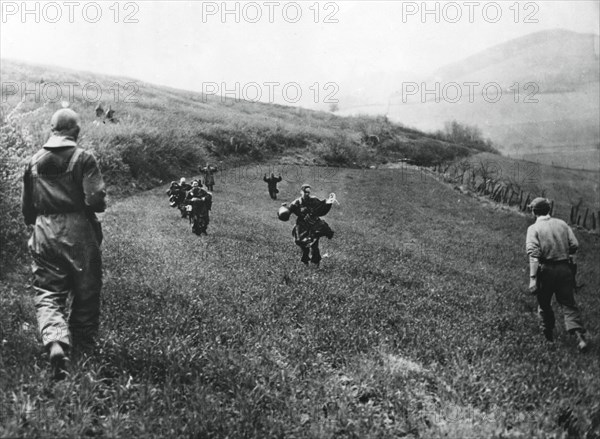 German troops surrendering to soldiers of the American 1st Army, near Elsborn, Germany, April 1945. Artist: Unknown