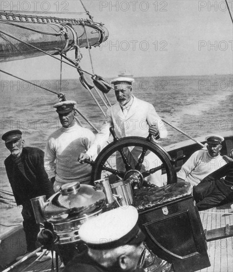 King George V at the helm of his yacht Britannia, c1930s. Artist: Unknown