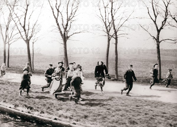 Children running alongside a canal, Monnickendam, Netherlands, 1898.Artist: James Batkin