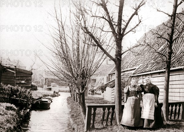 Two women on a canal bank, Broek, Netherlands, 1898.Artist: James Batkin