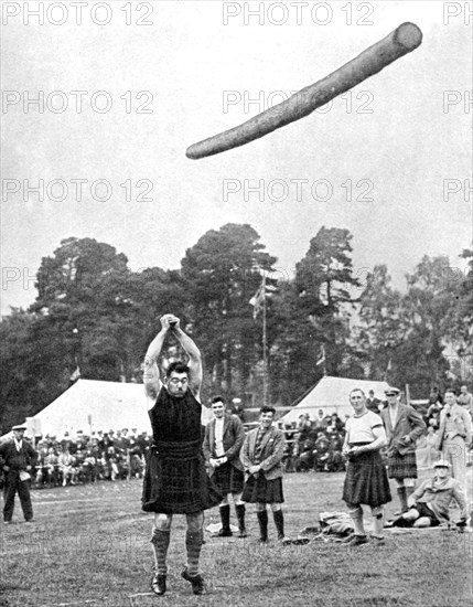 Tossing the caber at the Highland games, Scotland, 1936. Artist: Fox