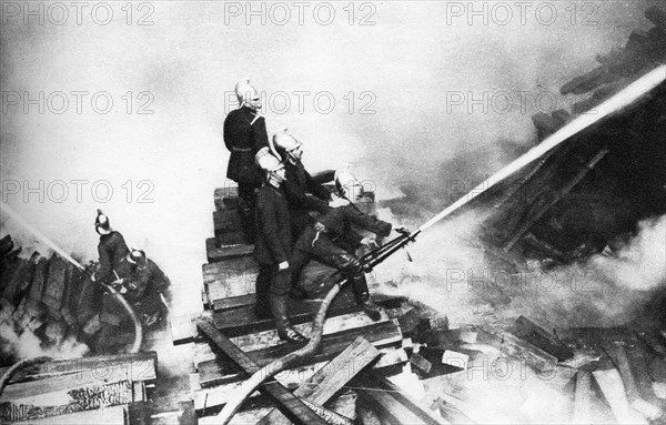 Firemen fighting a fire at a timber yard, London, 1926-1927. Artist: Unknown