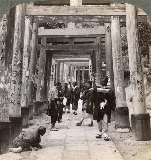 Coming and going under long rows of sacred torii, Shinto temple of Inari, Kyoto, Japan, 1904. Artist: Underwood & Underwood