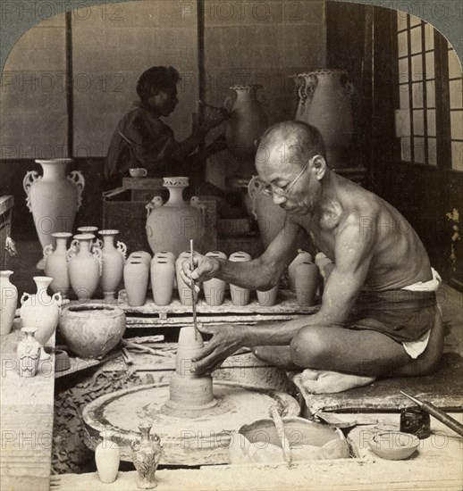 A potter and his wheel, fashioning a vase of Awata porcelain, Kinkosan works, Kyoto, Japan, 1904. Artist: Underwood & Underwood