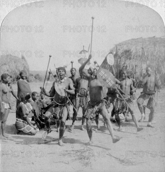'Heroic sports of the Kraal, a Zulu war dance', Zululand, South Africa, 1901. Artist: Underwood & Underwood