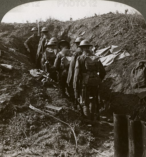 Officer watching his men file into a dug-out to avoid a German strafe, World War I, 1914-1918.Artist: Realistic Travels Publishers