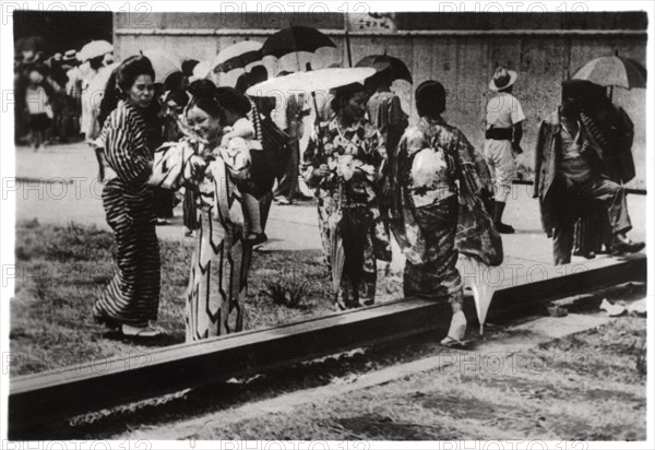 Japanese women by the Zeppelin hangar, Kasumigaura, Japan, 1929 (1933). Artist: Unknown