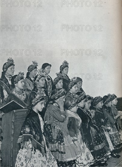 'Hungarian Peasant Girls Singing in Church', c1932. Artist: Rudolf Balogh.