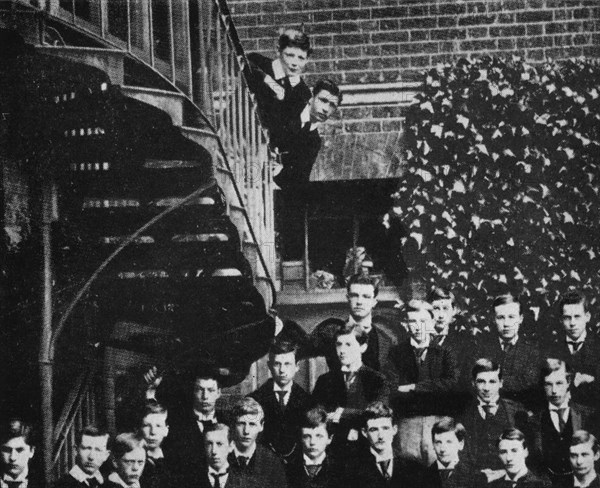 'Winston climbing a staircase, while the class pose', c1889, (1945). Artist: Unknown.