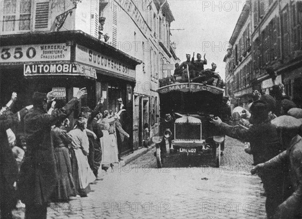 'British troops receive a welcome as they arrive by motor van in a French town', 1915. Artist: Unknown.